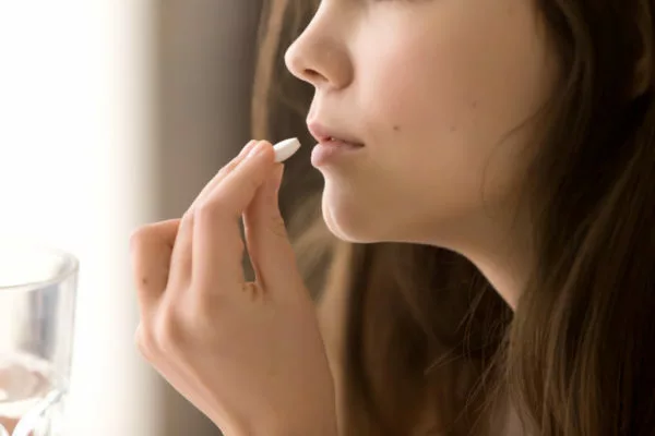 Wedding Day Emergency Kit - Brunette Woman Taking A White Pill