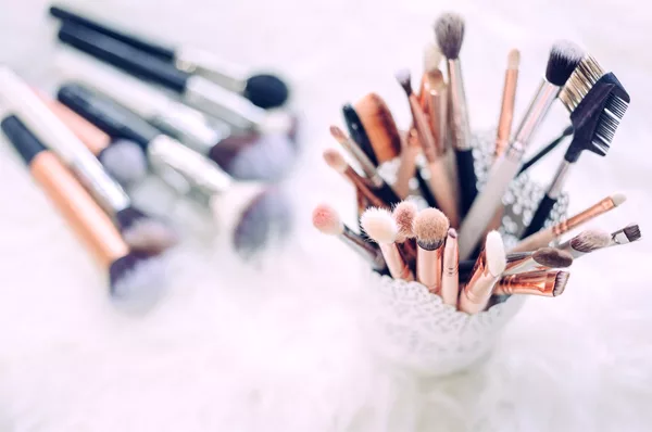 Wedding Makeup Artist - Various Brushes In A Cup And Lying On Table