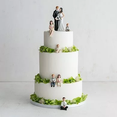 Family With Kids Wedding Cake Toppers On White Cake With Green Trim