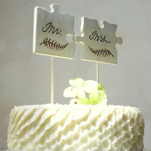 Puzzle Piece Wedding Cake Toppers On White Textured Cake