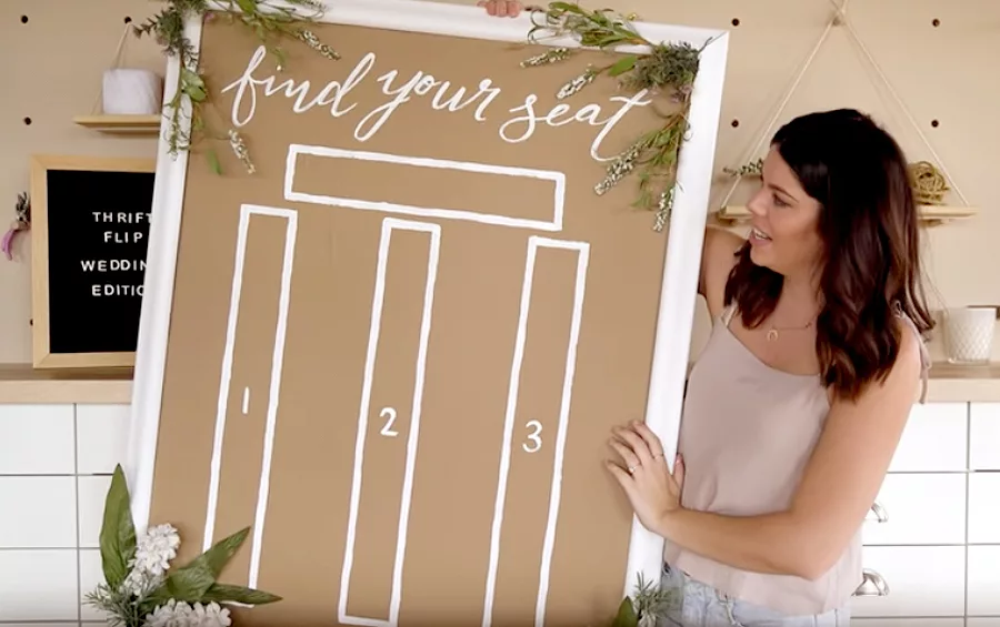 Wedding Hacks - Brunette Woman Holding Up Seating Chart