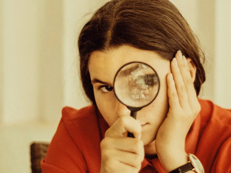 Brunette Woman With Magnifying Glass