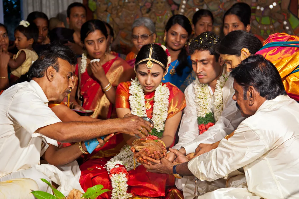 Indian people gathered together at a wedding at an Indian wedding venue