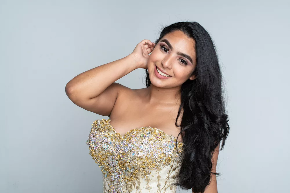 Young women in gold quinceanera dress.