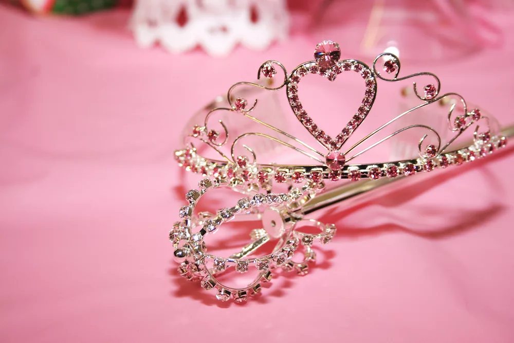 Crown on top of a pink sheet.